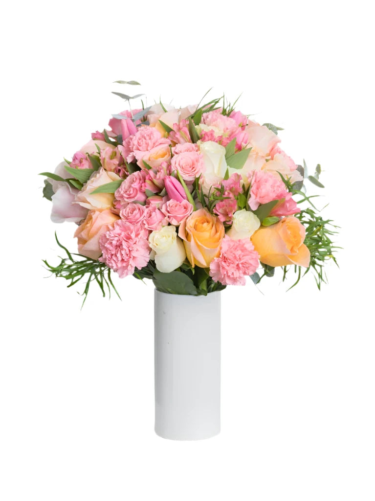 A floral arrangement featuring a mix of pink, white, and peach roses, along with carnations, tulips, and eucalyptus greenery in a white vase.